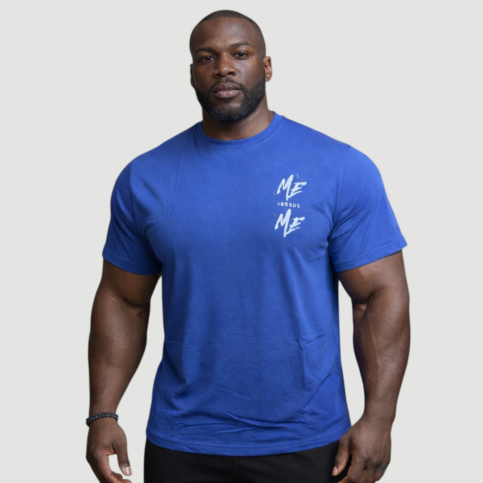 Man wearing a blue t-shirt with a logo on a plain background