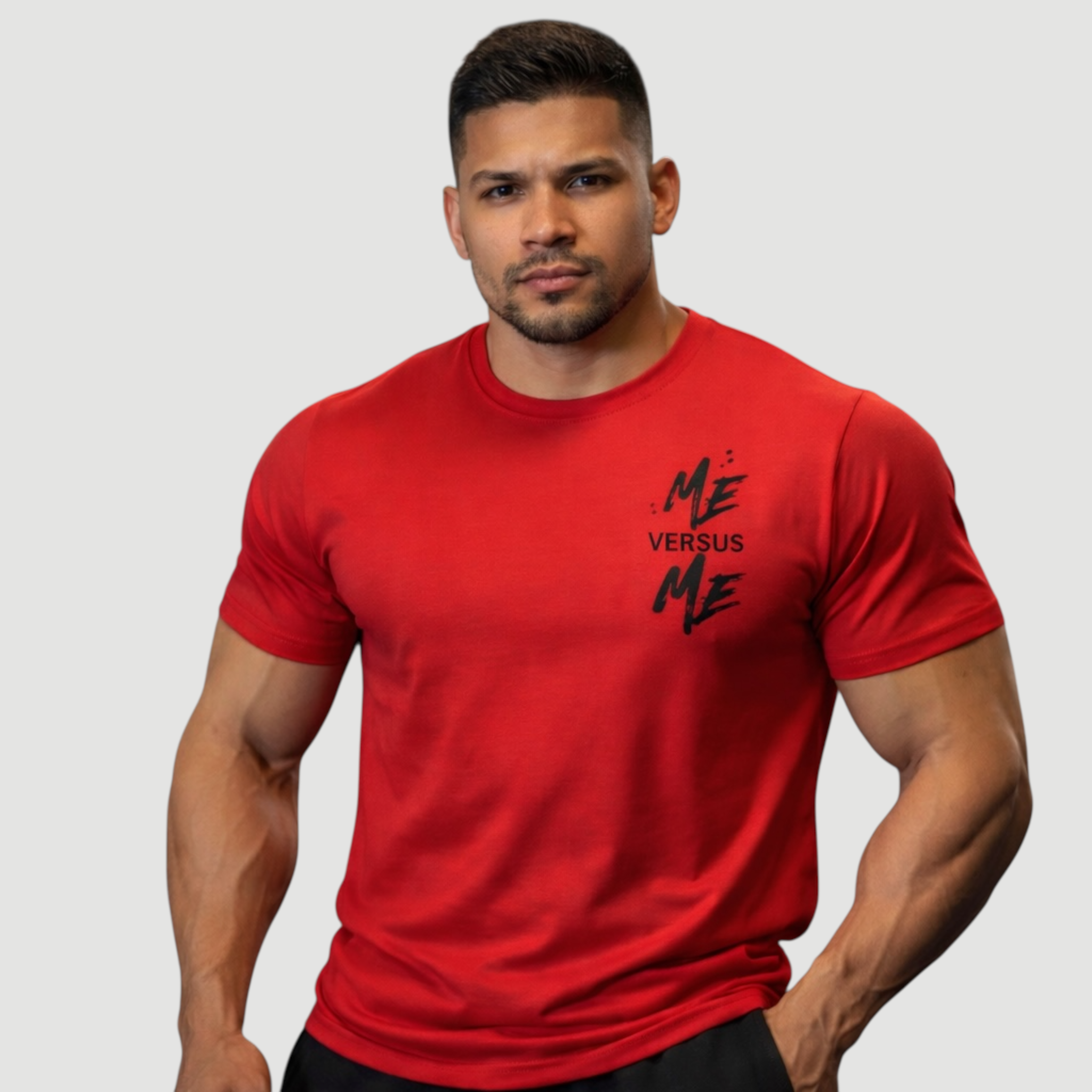 Man wearing a red t-shirt with 'Me Versus Me' text on a gray background